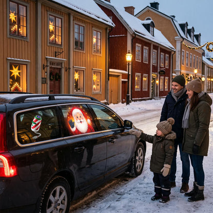 Julprojektor visar tomten på bilrutan en vinterkväll